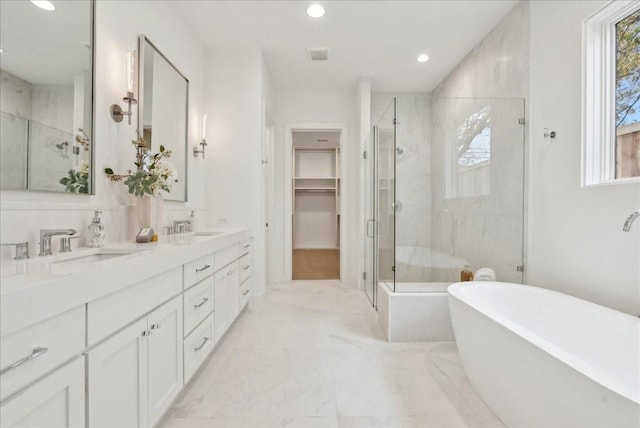 bathroom with vanity and independent shower and bath