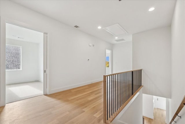 hallway with light hardwood / wood-style flooring