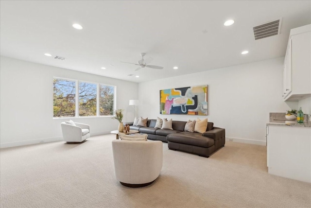 living room with ceiling fan and light colored carpet