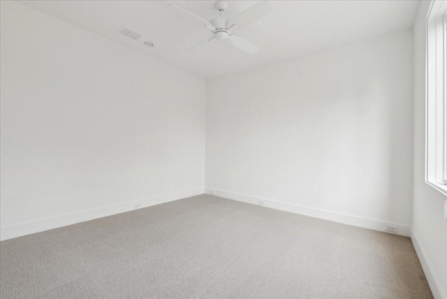 carpeted empty room with ceiling fan