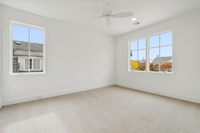 spare room with carpet flooring and ceiling fan