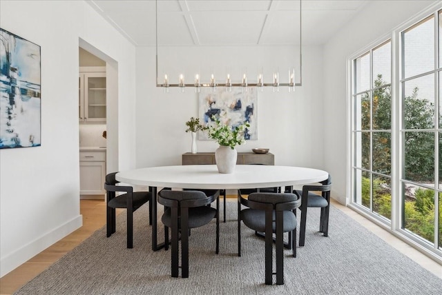 dining room with a chandelier, hardwood / wood-style floors, and a healthy amount of sunlight