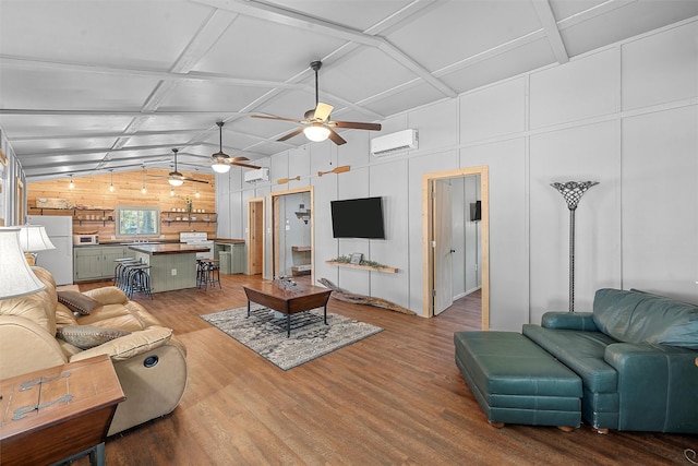 living room featuring an AC wall unit, vaulted ceiling, and hardwood / wood-style flooring