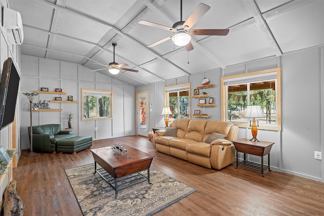 living room with ceiling fan, a healthy amount of sunlight, wood-type flooring, and coffered ceiling