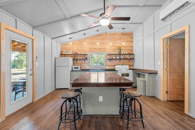 kitchen featuring a kitchen breakfast bar, white appliances, wooden walls, and a wall mounted AC