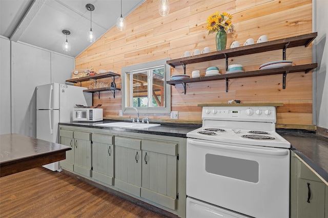 kitchen featuring white appliances, sink, wooden walls, and vaulted ceiling