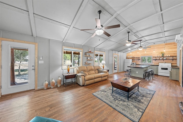 living room featuring hardwood / wood-style floors, lofted ceiling with beams, and wooden walls