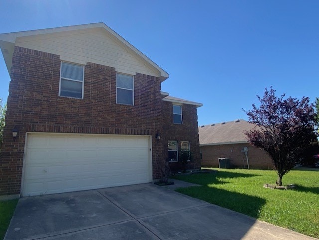 traditional-style house with an attached garage, central AC, brick siding, driveway, and a front lawn