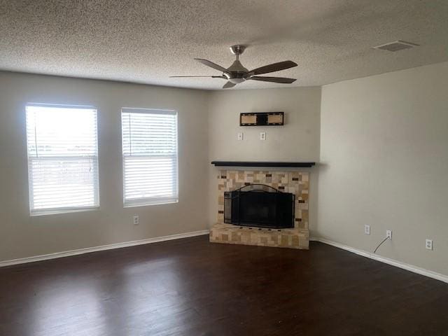 unfurnished living room featuring a textured ceiling, dark hardwood / wood-style floors, and ceiling fan