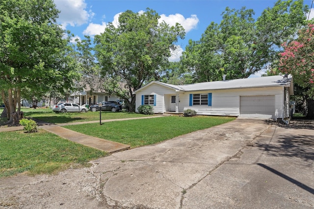 ranch-style home featuring a garage and a front lawn