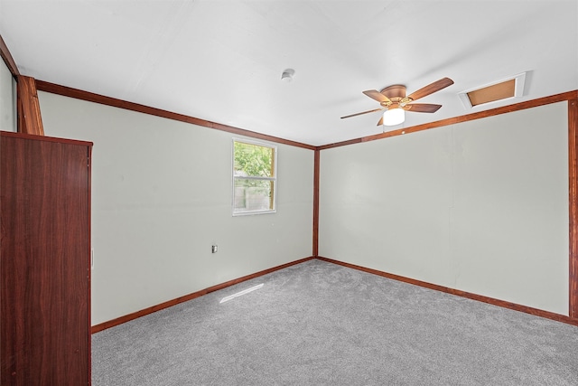 carpeted spare room featuring ceiling fan