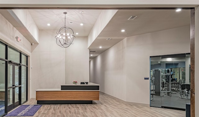 reception area with french doors and a chandelier