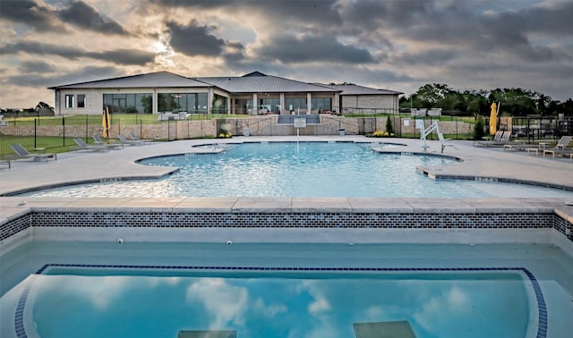 view of swimming pool with a jacuzzi and a patio area