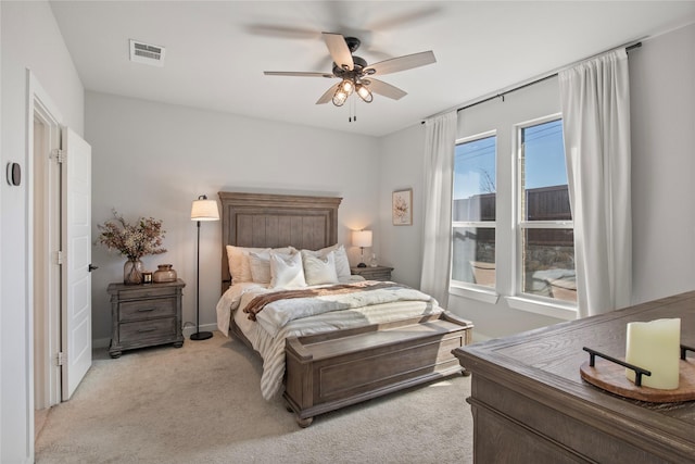 bedroom with ceiling fan and light carpet