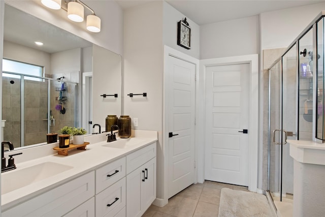 bathroom with walk in shower, vanity, and tile patterned floors