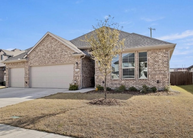 view of front of property with a front lawn and a garage