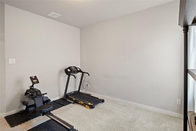 workout area featuring light colored carpet