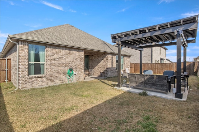 back of house featuring a lawn and a pergola