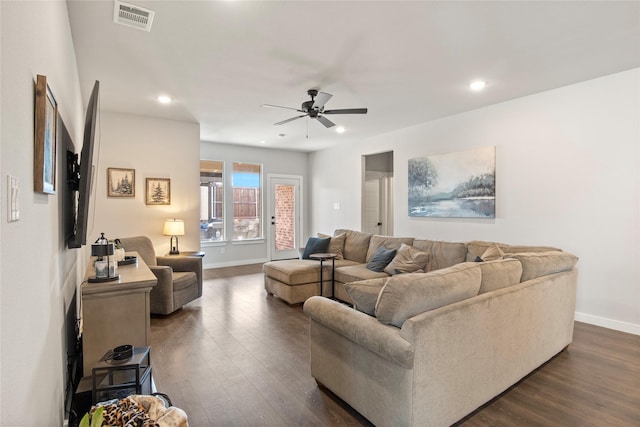 living room featuring ceiling fan and dark hardwood / wood-style flooring