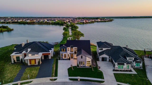 aerial view at dusk with a water view