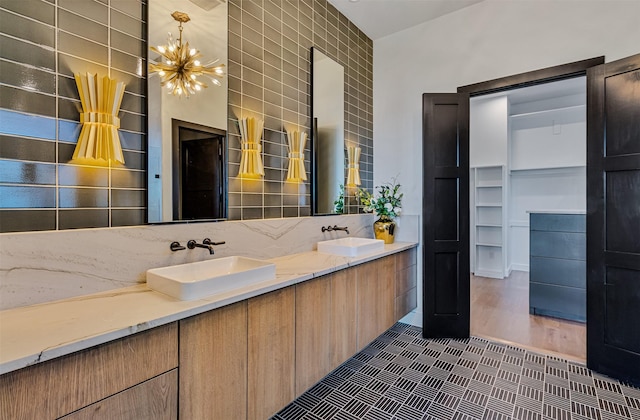 bathroom with vanity, wood-type flooring, and a notable chandelier