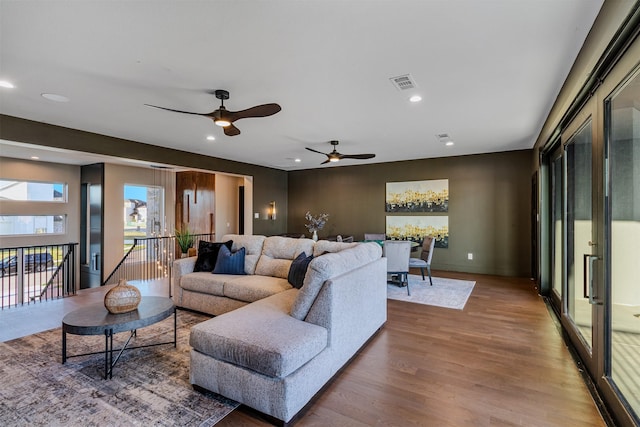 living room featuring hardwood / wood-style flooring and ceiling fan