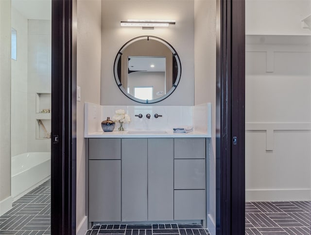 bathroom featuring vanity and a bath