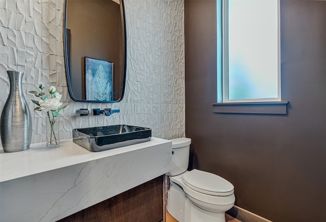 bathroom featuring tasteful backsplash, vanity, and toilet