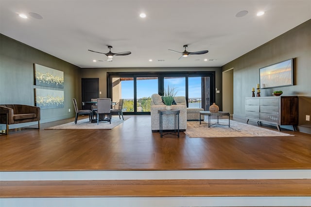 living room featuring hardwood / wood-style floors and ceiling fan