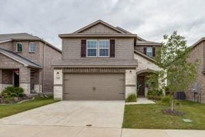 view of front of home featuring a front yard and a garage