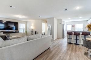 living room with light hardwood / wood-style flooring