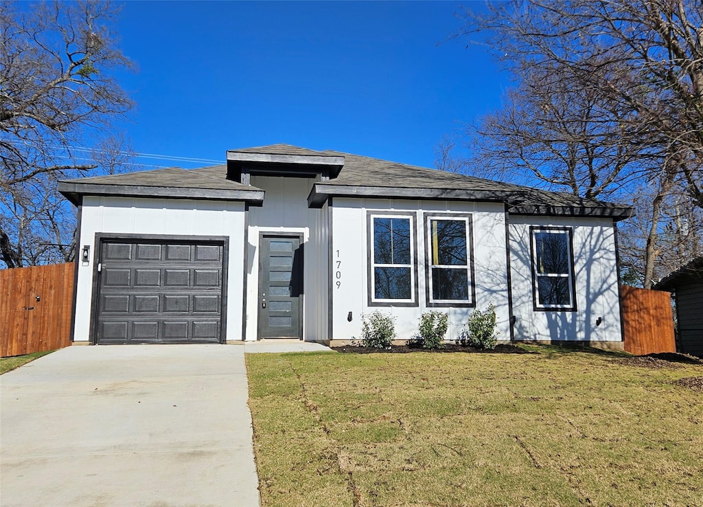 view of front facade with a garage and a front lawn