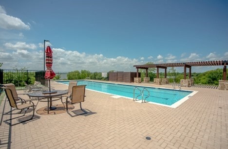 view of swimming pool featuring a pergola and a patio area