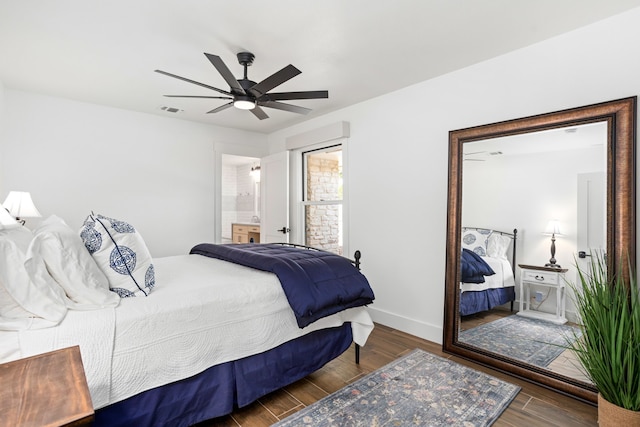 bedroom featuring connected bathroom, ceiling fan, and dark wood-type flooring