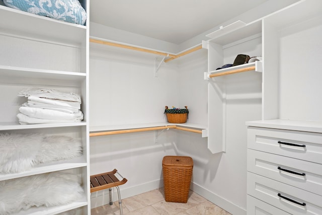 spacious closet with light tile patterned floors