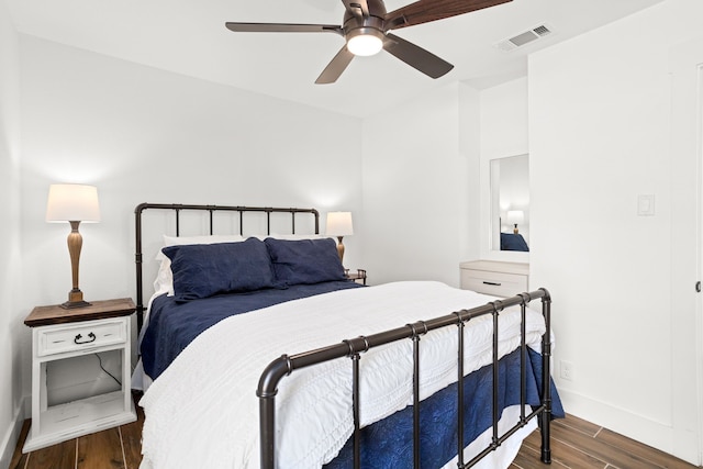 bedroom with ceiling fan and dark hardwood / wood-style flooring