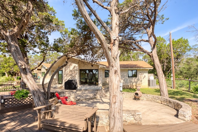 exterior space with a deck and central AC