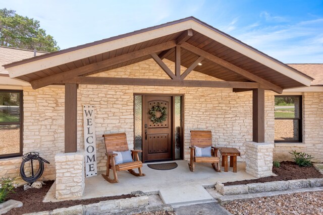 120 Canteen, Canyon Lake, TX 78133 - doorway to property featuring a porch and stone siding