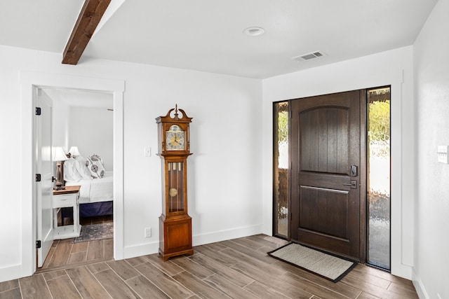 foyer featuring beamed ceiling