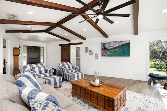 living room with vaulted ceiling with beams, a barn door, and ceiling fan