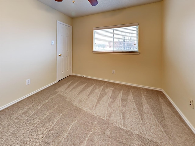 unfurnished room with ceiling fan, carpet flooring, and baseboards