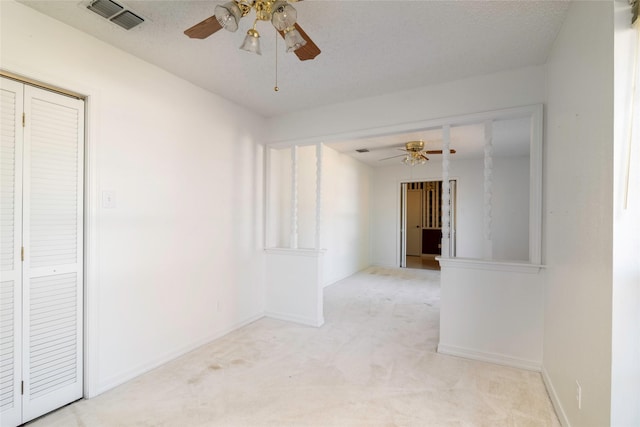 unfurnished room featuring light colored carpet and ceiling fan