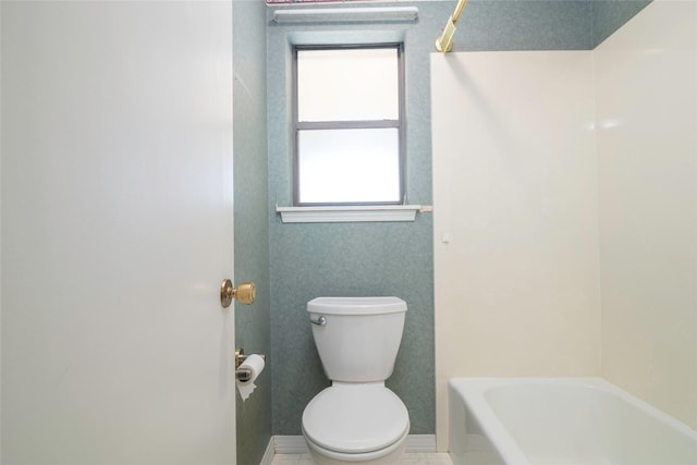 bathroom featuring toilet and a tub