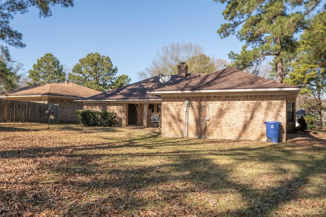 back of property with a lawn