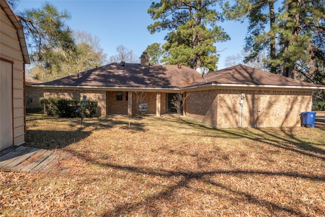 rear view of property featuring a yard