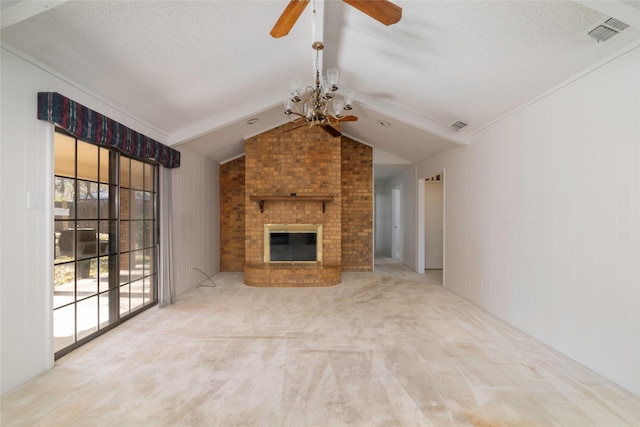 unfurnished living room with a textured ceiling, vaulted ceiling, light colored carpet, ceiling fan with notable chandelier, and a fireplace