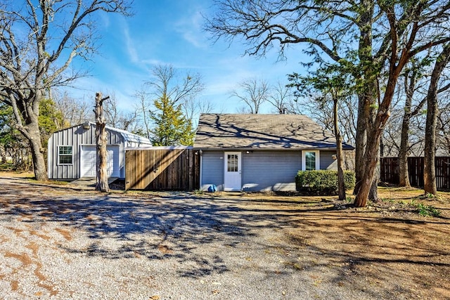 view of property exterior with a garage and an outdoor structure