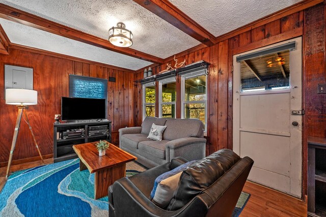 40 Zumwalt Cir, Pottsboro, TX 75076 - living area featuring beam ceiling, wood walls, wood finished floors, and a textured ceiling