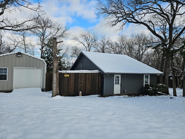 snow covered property featuring a garage