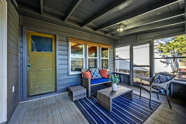 sunroom / solarium featuring beamed ceiling and wooden ceiling